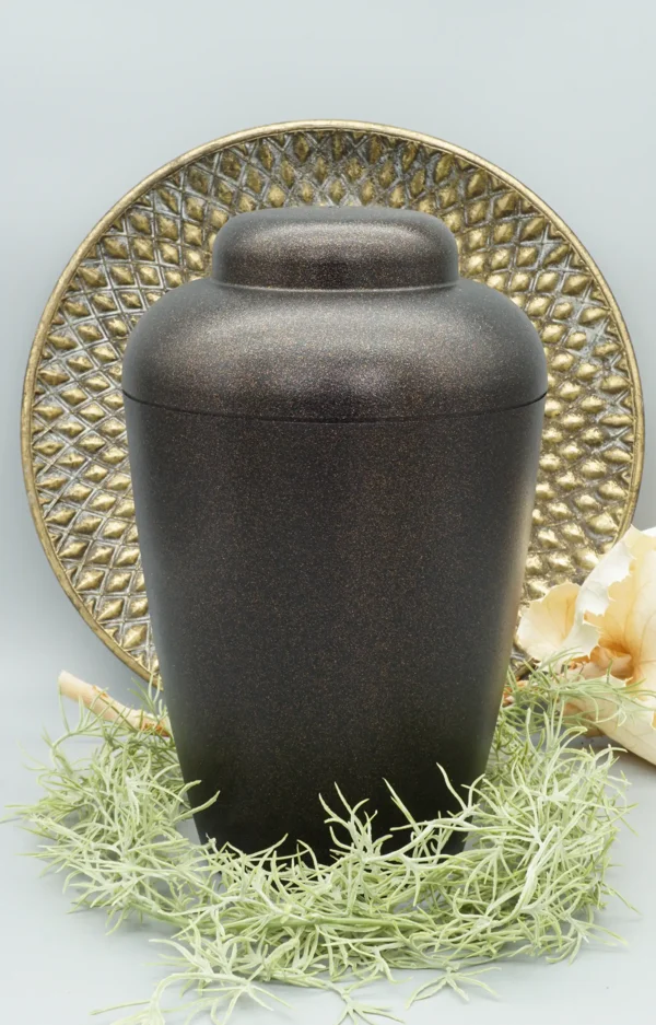 Bio Urne VALE schwarz gold Glitzer mit dekorativem Hintergrund